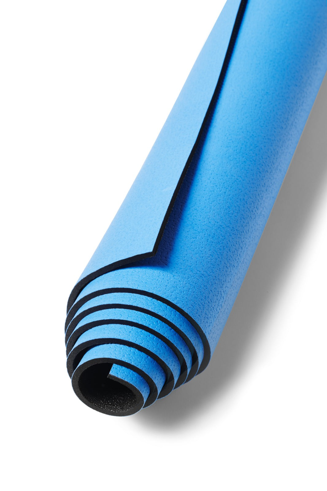Detail of the rolled blue yoga mat with visible black underside